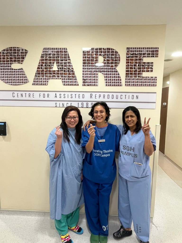 Dr. Chandini Chinta in Operating Theatre SGH Campus scrubs with colleagues at the Centre for Assisted Reproduction, Singapore General Hospital